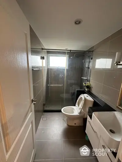 Modern bathroom with sleek design, glass shower, and contemporary fixtures.