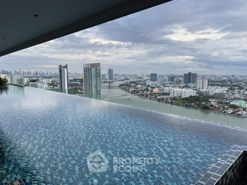 Stunning rooftop infinity pool with panoramic city skyline and river view.