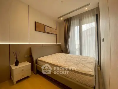 Modern bedroom with stylish decor and large window for natural light.