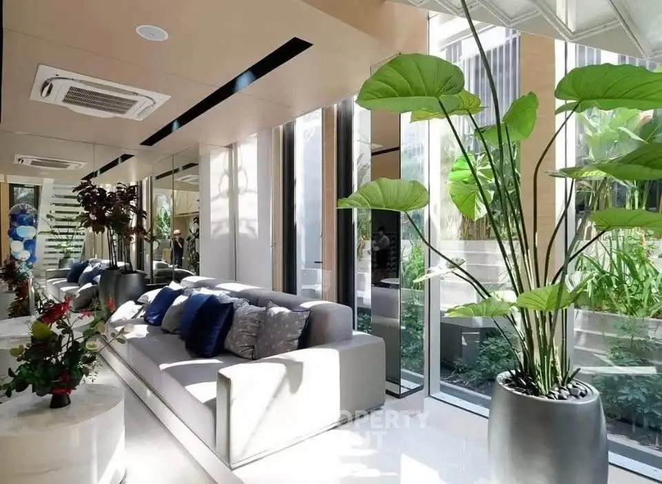 Luxurious modern living room with large windows and lush indoor plants