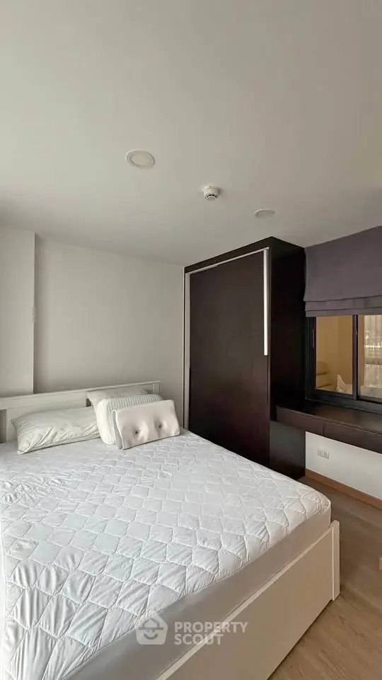 Modern bedroom with sleek design and ample natural light, featuring a comfortable bed and stylish decor.