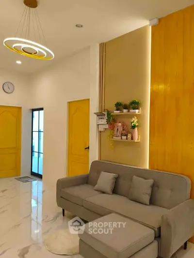 Modern living room with stylish sofa and elegant lighting in a cozy apartment.
