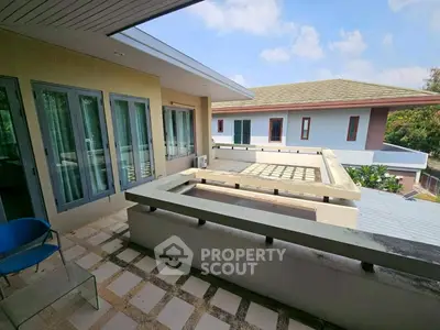 Spacious balcony with modern design and scenic view in a luxury property.