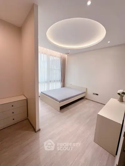 Modern minimalist bedroom with elegant lighting and large window