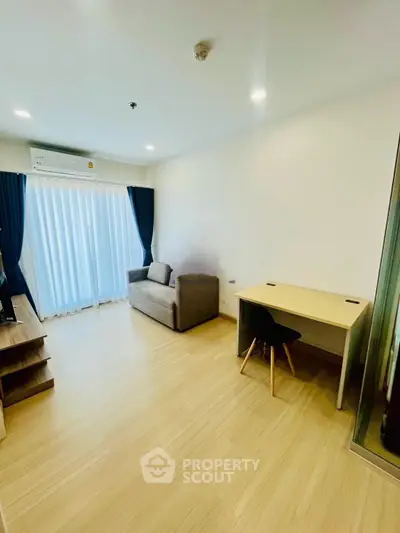 Modern living room with sleek furniture and natural light, perfect for urban living.