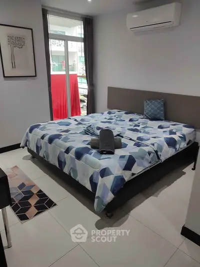 Modern bedroom with stylish decor and large window for natural light