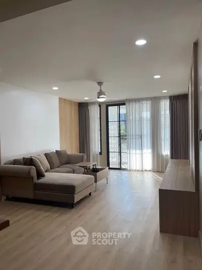 Spacious living room with modern decor and large windows for natural light.