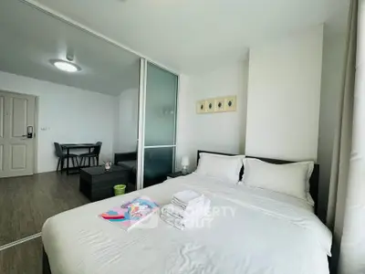 Modern bedroom with white bedding and glass partition in stylish apartment