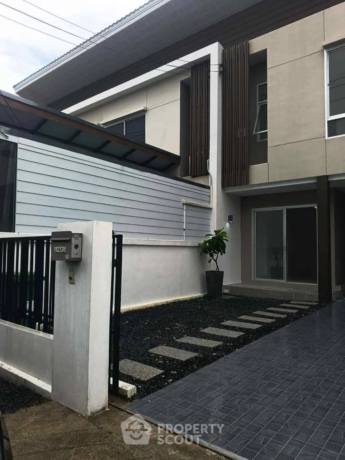 Modern two-story house with sleek design and spacious driveway