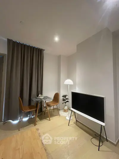 Modern living room with sleek TV and cozy dining area