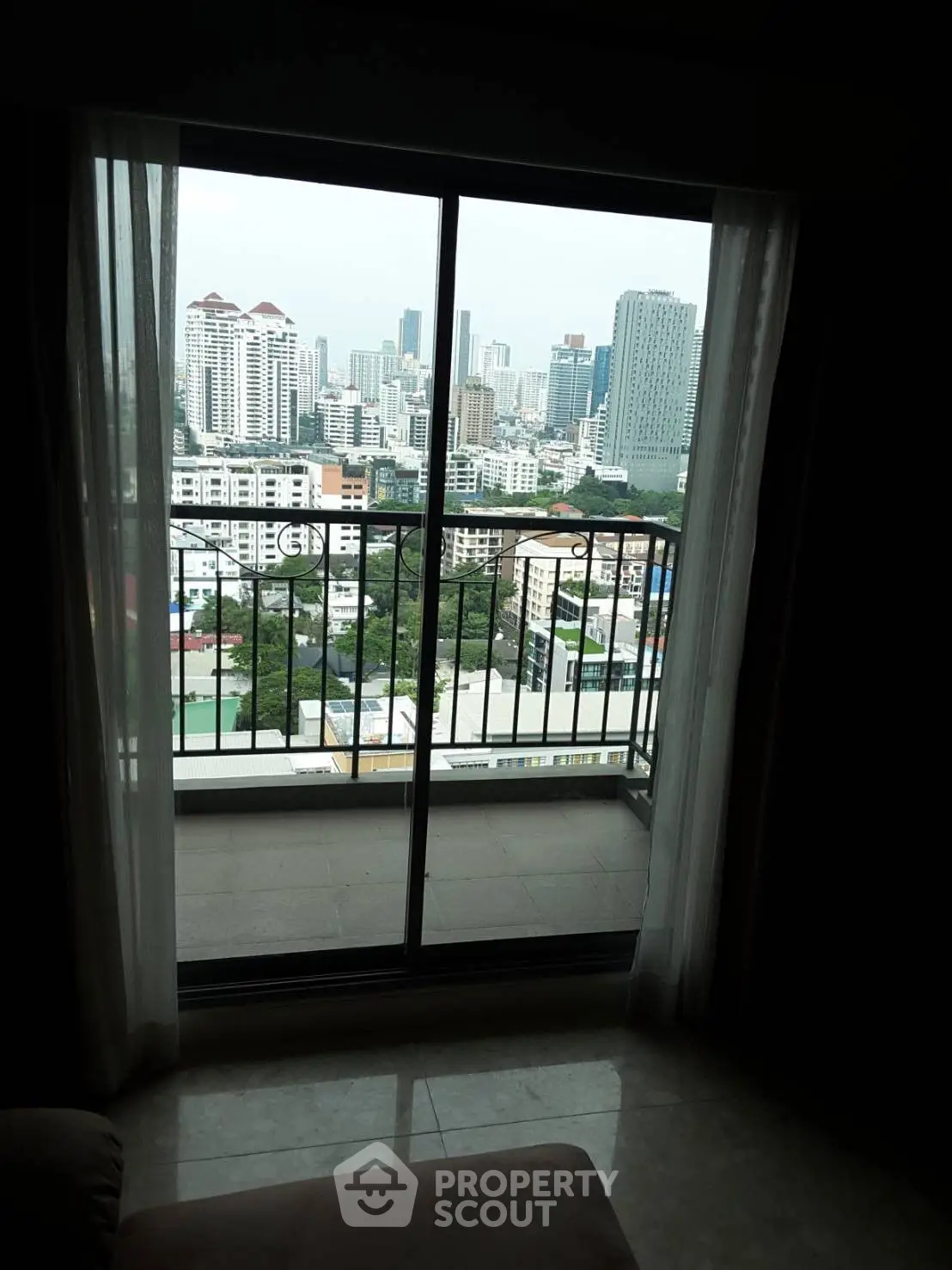 Stunning cityscape view from high-rise apartment balcony