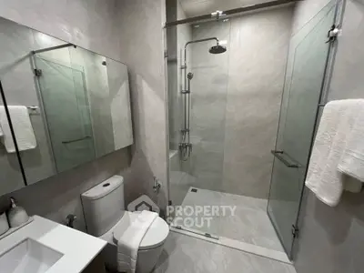 Modern bathroom with glass shower and sleek fixtures