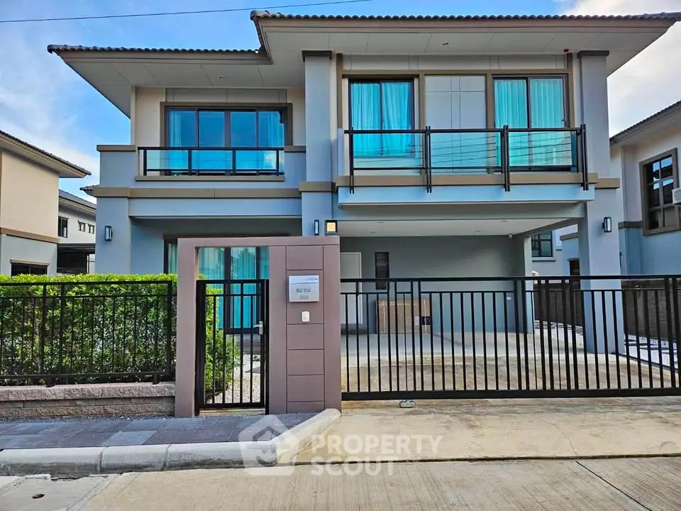 Modern two-story house with sleek design and spacious driveway in a serene neighborhood.