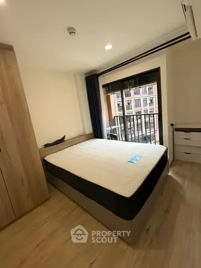 Modern bedroom with large window and balcony view in stylish apartment