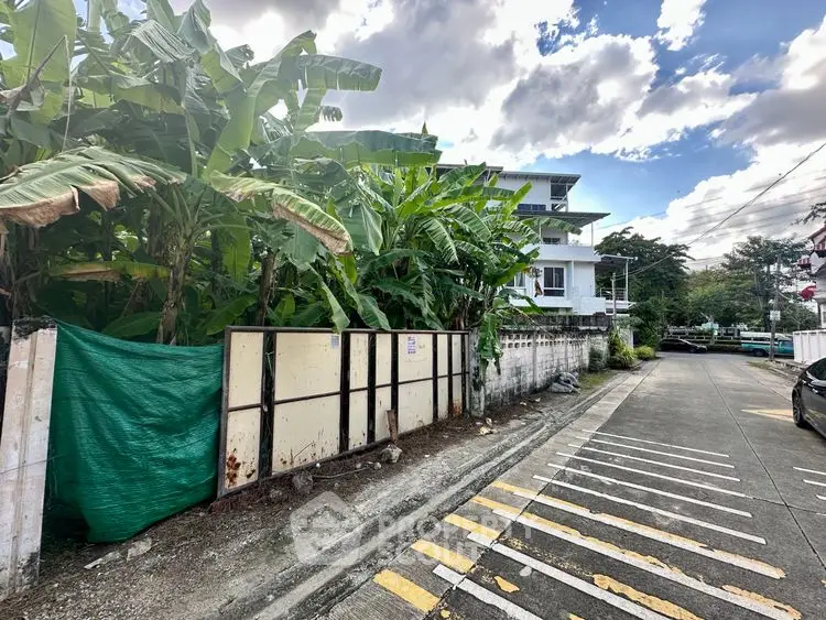 Charming residential building with lush greenery and spacious surroundings.