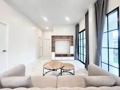 Spacious modern living room with elegant furniture and large windows for natural light.