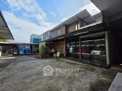 Spacious industrial-style property with ample parking and modern exterior design.