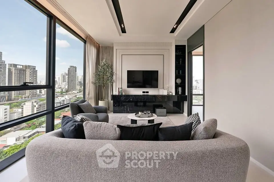 Luxurious modern living room with panoramic city views and elegant furnishings.