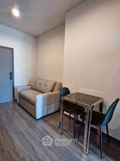 Modern living room with sleek sofa and dining table in a stylish apartment.