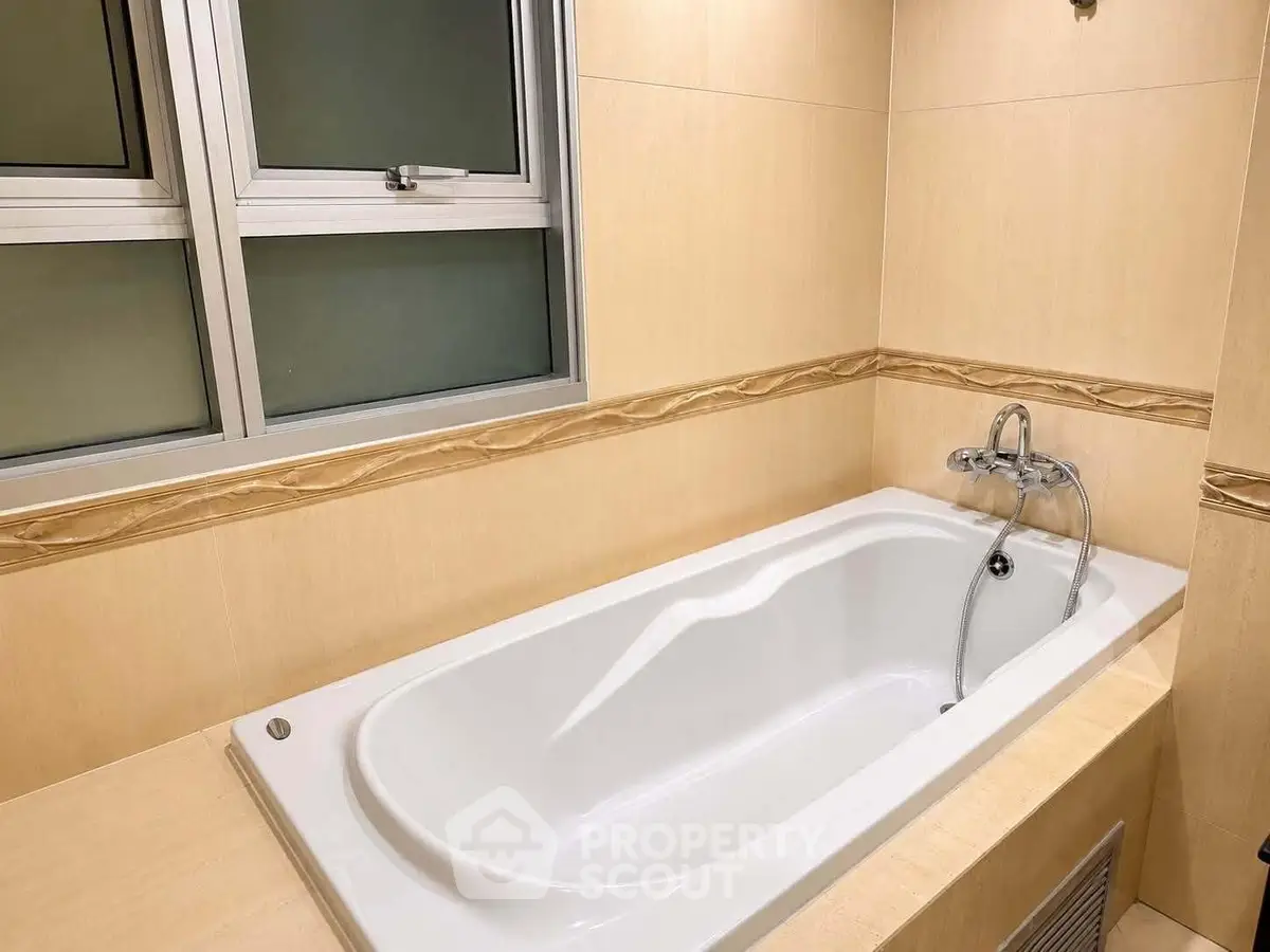 Elegant bathroom with a built-in bathtub and modern fixtures, perfect for relaxation.