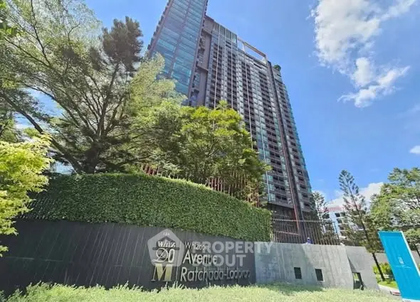 Modern high-rise building with lush greenery at Whizdom Avenue Ratchada-Ladprao.