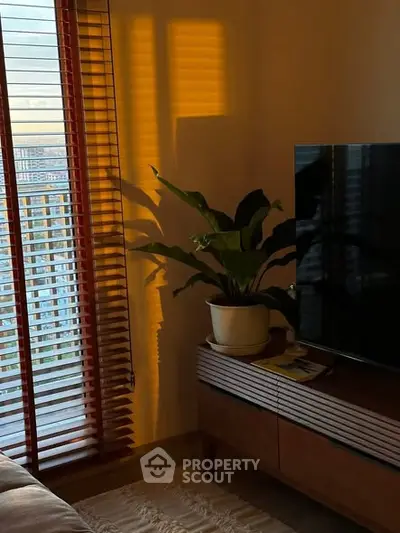 Cozy living room with modern TV stand and large window view