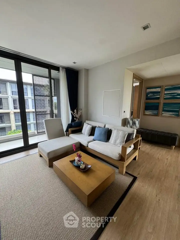 Spacious modern living room with elegant decor and large windows offering natural light.