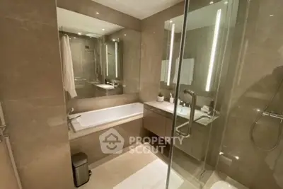 Luxurious modern bathroom with glass shower and bathtub in elegant design.