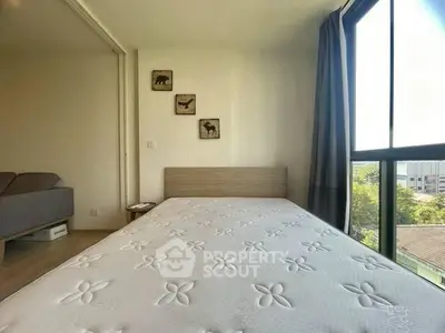 Bright bedroom with large window and minimalist decor