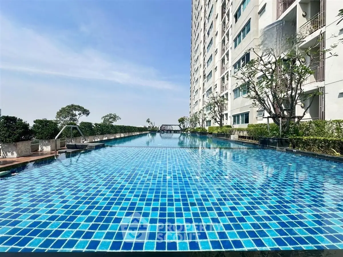 Luxurious high-rise apartment with stunning rooftop pool and panoramic city views.