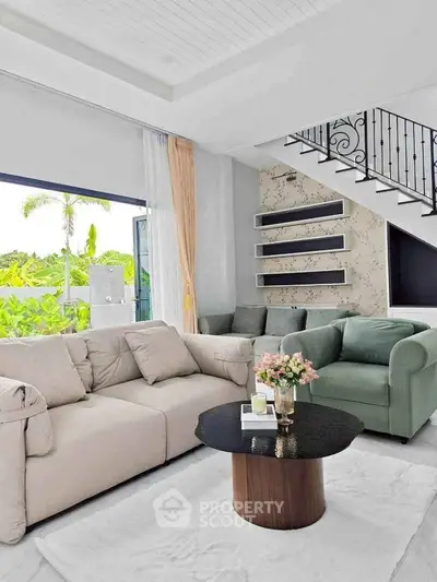 Elegant living room with modern furniture and garden view, perfect for relaxation.