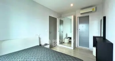 Modern bedroom with sleek design, featuring a mirrored wardrobe and air conditioning for comfort.