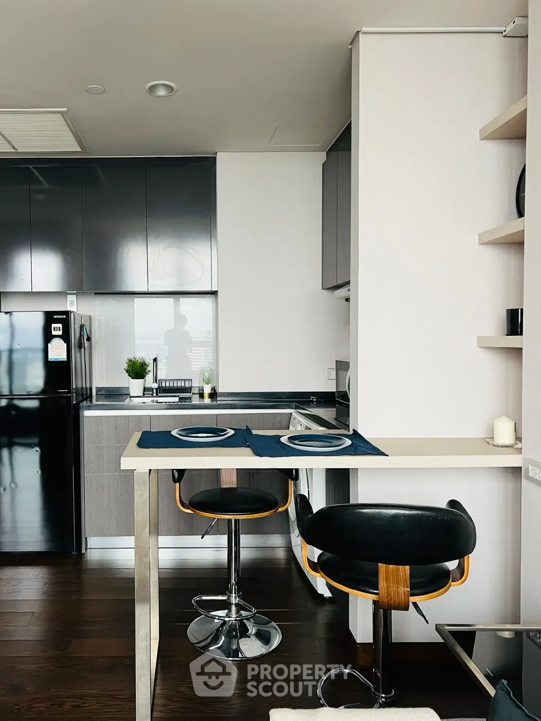 Modern kitchen with sleek cabinetry and breakfast bar in stylish apartment