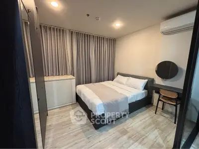 Modern bedroom with cozy bed, stylish decor, and natural light for a comfortable living experience.