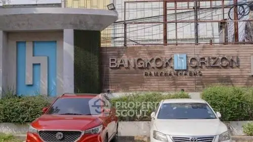 Bangkok Horizon building entrance with parked cars and modern signage.