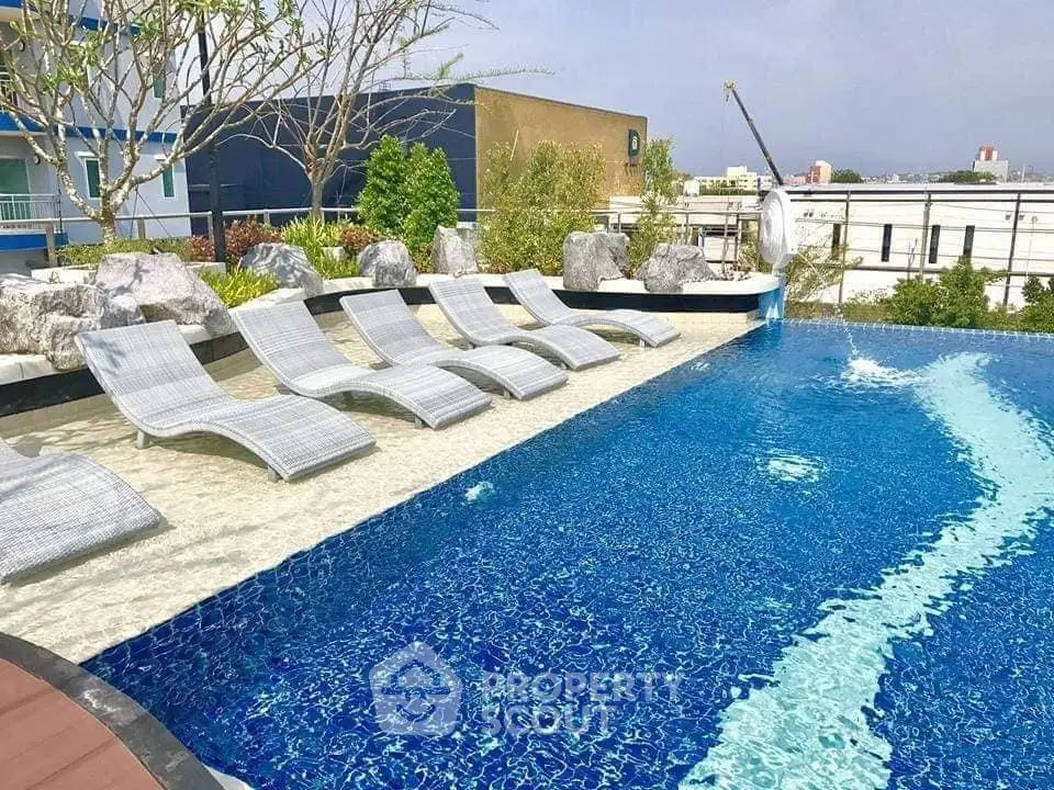 Luxurious rooftop pool with stylish loungers and city views, perfect for relaxation and leisure.