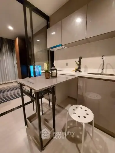 Modern kitchen with sleek cabinetry and breakfast bar in a stylish apartment