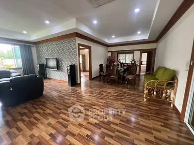 Spacious living room with modern decor and wooden flooring