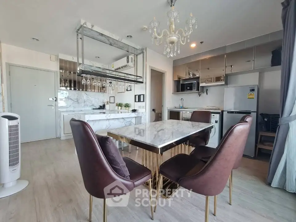 Luxurious modern kitchen with marble countertops and elegant dining area in high-end apartment.