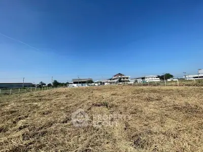 Expansive land plot with clear blue sky, ideal for development or investment opportunities.