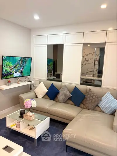 Modern living room with stylish sectional sofa and wall-mounted TV