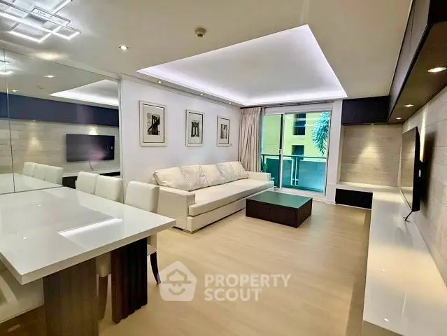 Modern living room with sleek design, featuring a large sofa, elegant dining area, and ambient lighting.
