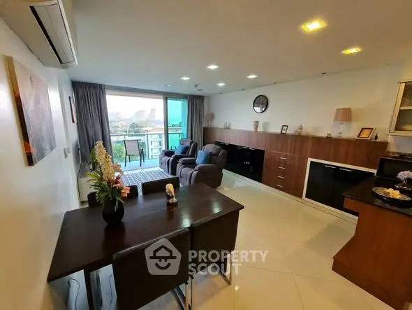 Spacious modern living room with balcony view and elegant furnishings