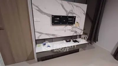 Modern living room with marble TV wall and sleek storage unit
