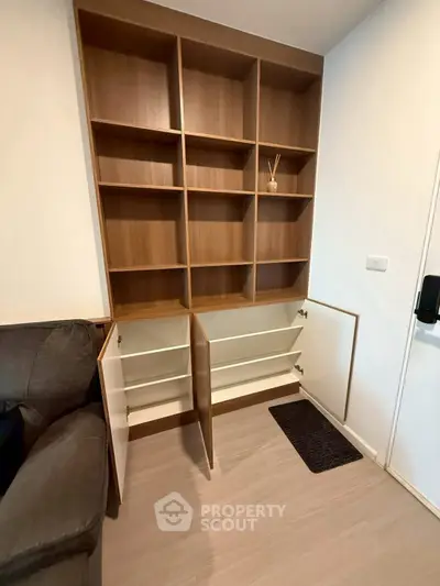 Modern living room with stylish wooden shelving unit and cozy sofa