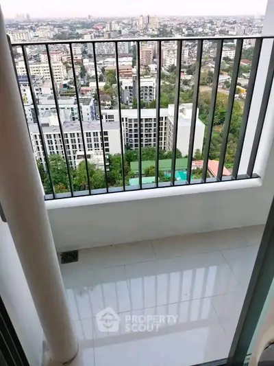 Stunning balcony view overlooking cityscape with lush greenery and modern buildings.