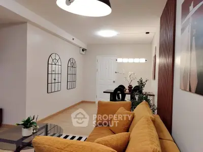 Stylish living room with modern decor and cozy seating in a contemporary apartment.
