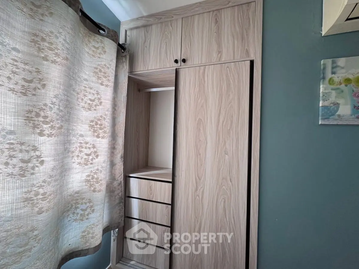 Modern wooden wardrobe with sliding doors in a stylish bedroom setting.