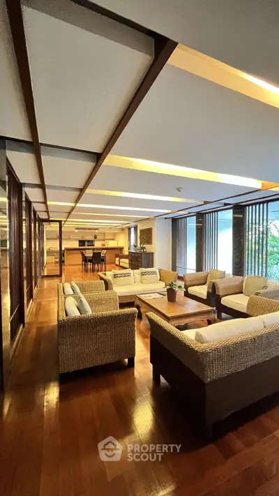 Spacious living room with elegant wooden flooring and modern furniture
