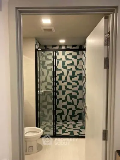 Modern bathroom with geometric tile shower and sleek design